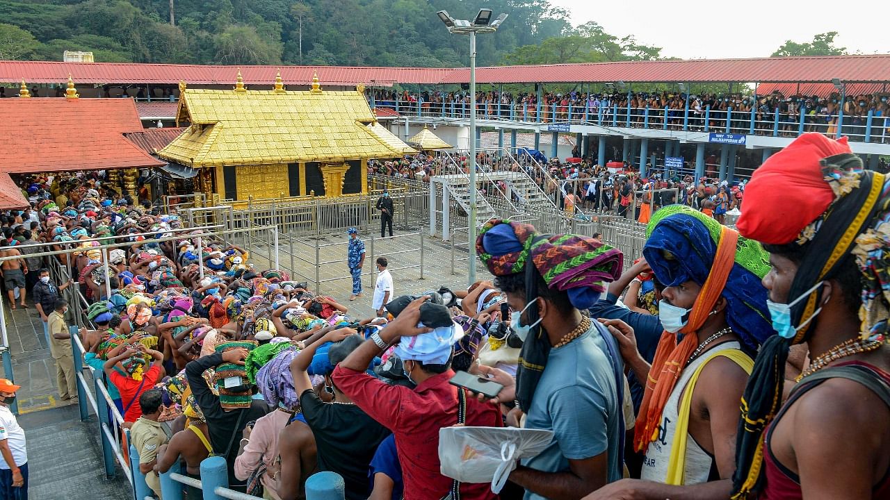 Devotees stand in a queue to visit the Sabarimala Temple in Pathanamthitta district, Saturday. Credit: PTI File Photo