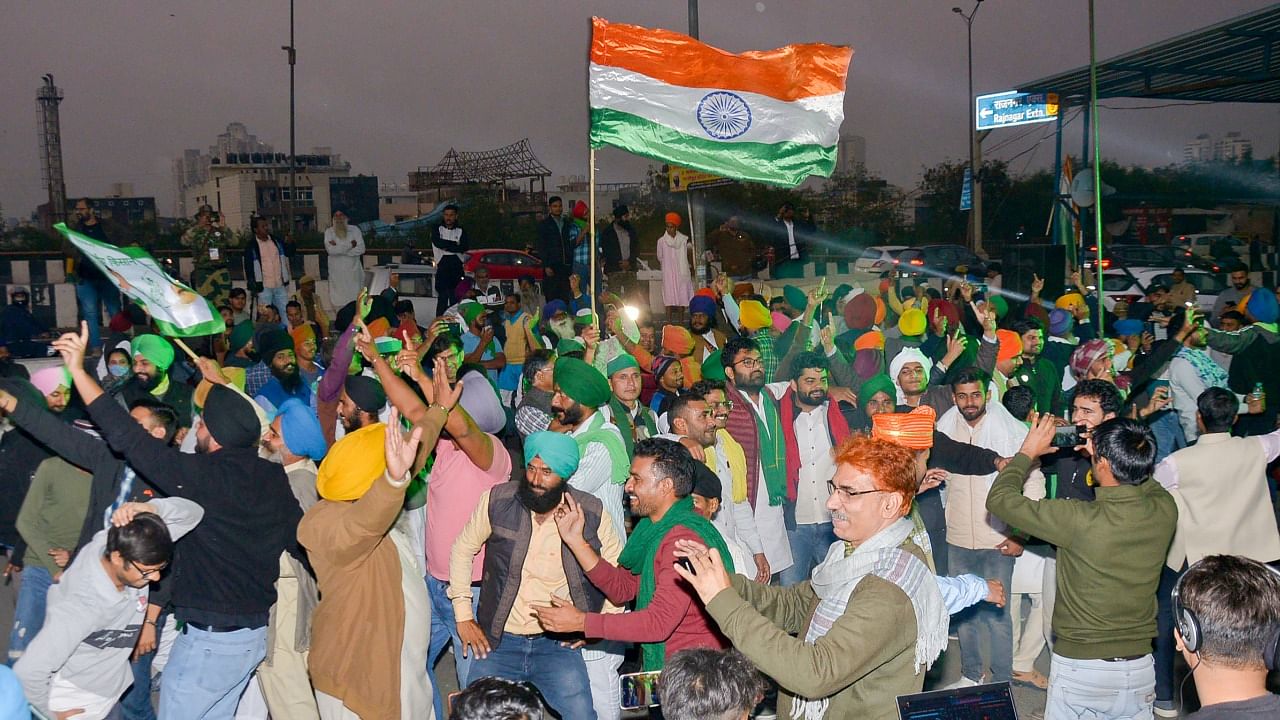 Farmers dance as they celebrate at the Ghazipur border. Credit: PTI Photo