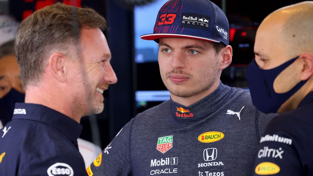 Red Bull's Dutch driver Max Verstappen (C) speaks with Red Bull's team principal Christian Horner. Credit: AFP Photo
