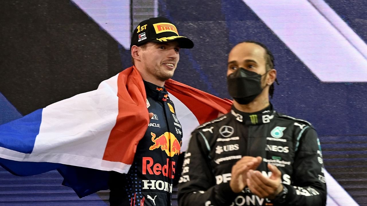 FIA Formula One World Champion Red Bull's Dutch driver Max Verstappen walks past second-placed Mercedes' British driver Lewis Hamilton (R). Credit: AFP Photo