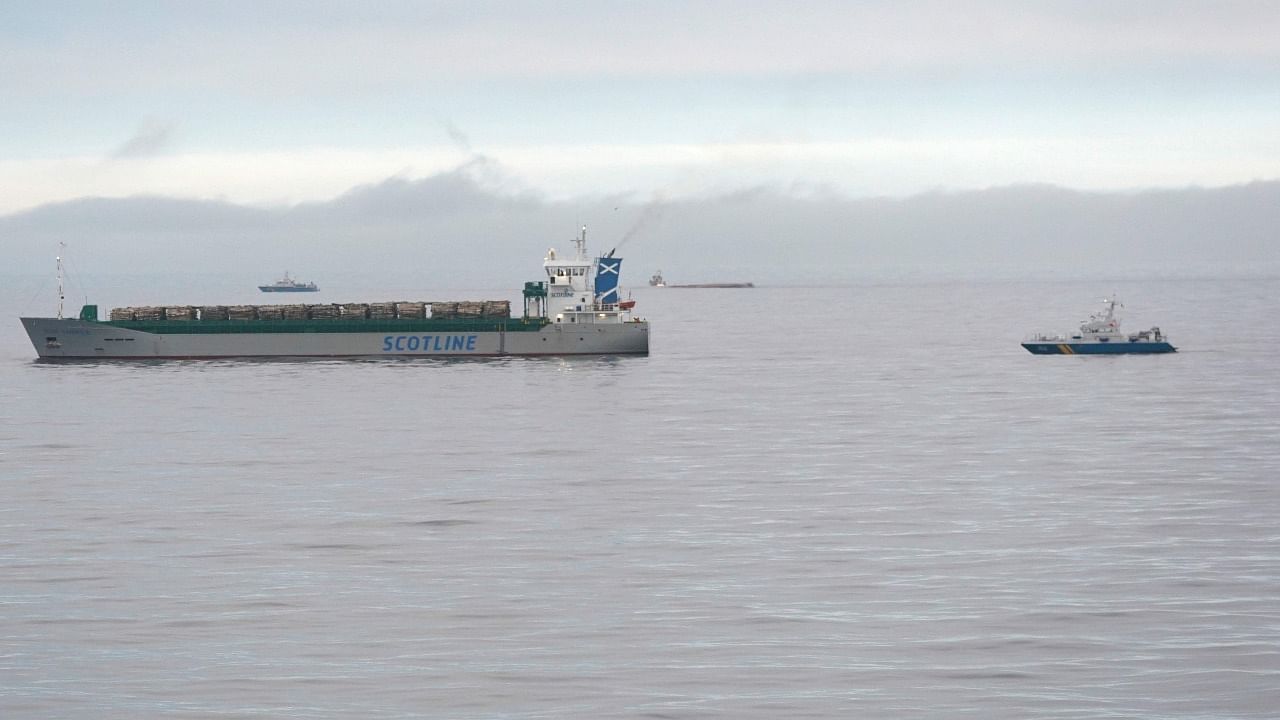 The British cargo ship Scot Carrier is seen at right after it collided with a Danish cargo ship Karin Hoej, seen capsized in the background center, in the Baltic Sea. Credit: AFP Photo