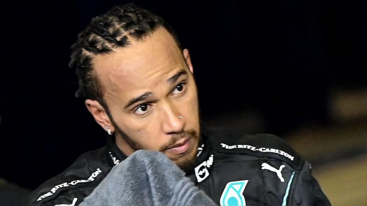 Second-placed Mercedes' British driver Lewis Hamilton reacts in the parc ferme of the Yas Marina Circuit after the Abu Dhabi Formula One Grand Prix on December 12, 2021. Credit: AFP Photo