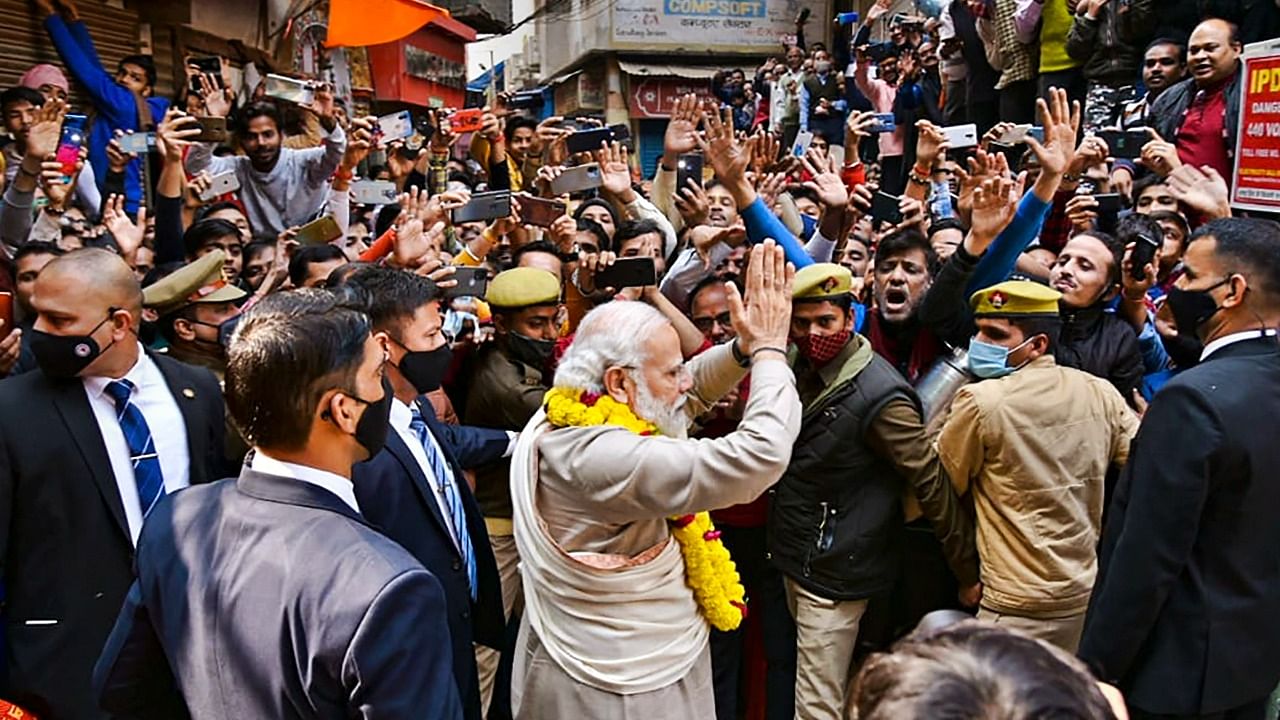 Prime Minister Narendra Modi greets people in his parliamentary constituency, in Varanasi. Credit: PTI Photo