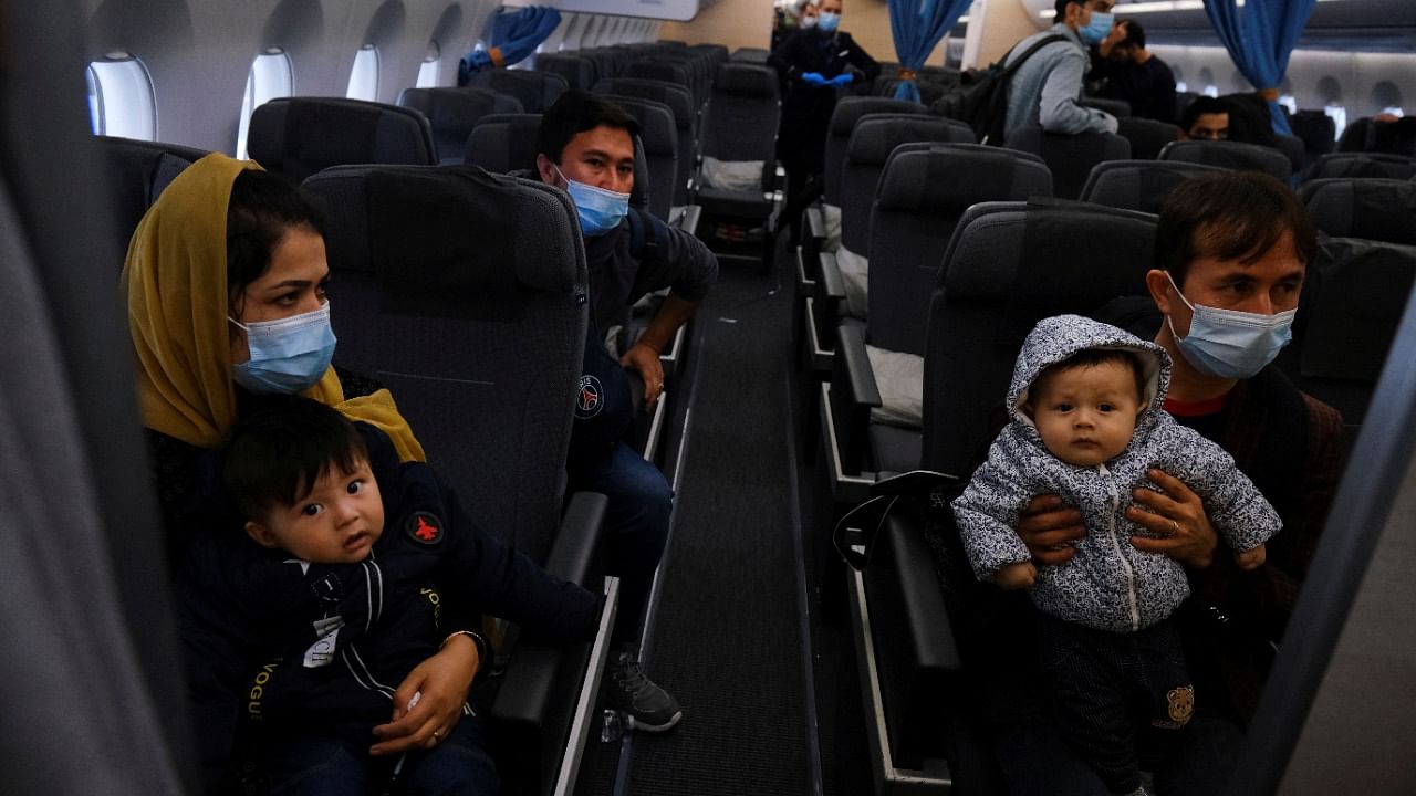 A group of Afghans that escaped from Kabul are seen inside an airplane after arriving at Lisbon. Credit: Reuters Photo