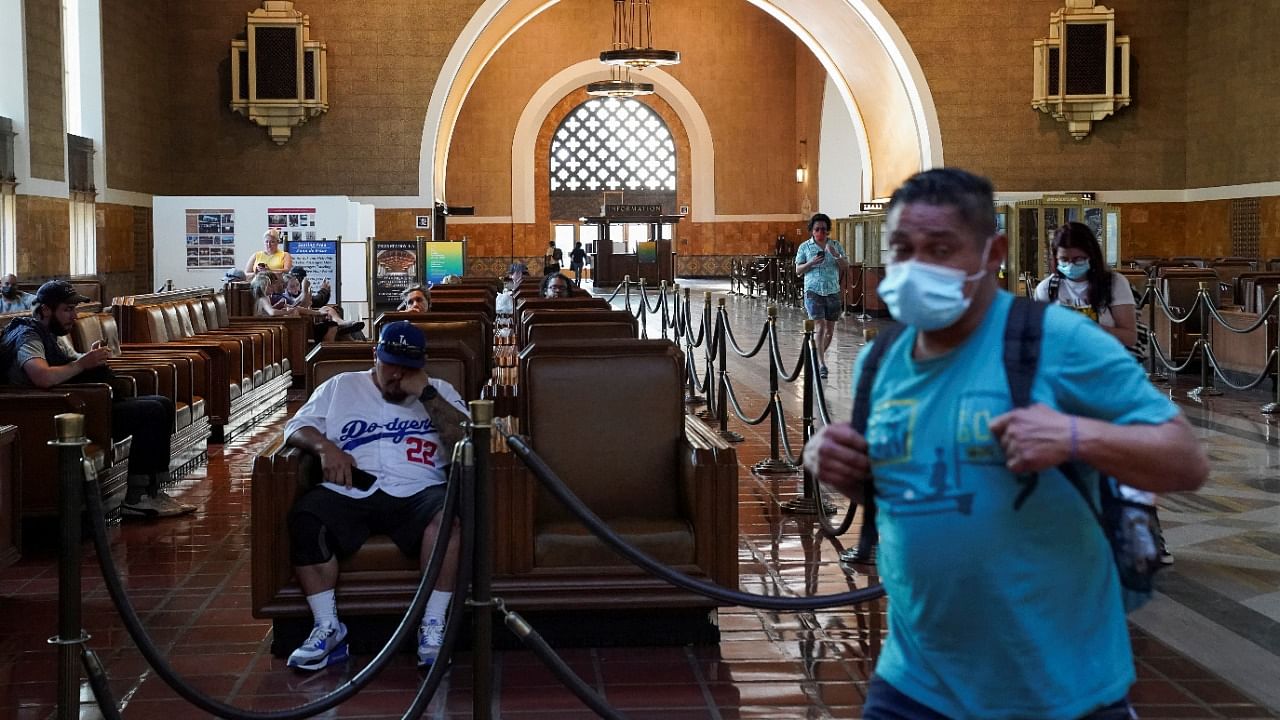  A traveller wearing a protective mask walks past a waiting area for Amtrak customers inside Union Station in downtown Los Angeles, California. Credit: Reuters File Photo