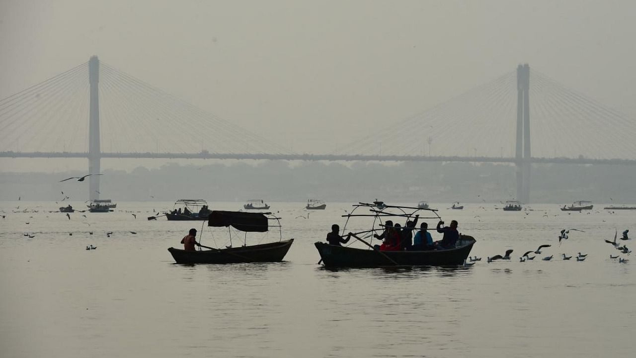 People take boat rides during a foggy evening at the Sangam, the confluence of the rivers Ganges, Yamuna and mythical Saraswati, in Allahabad. Credit: AFP File Photo