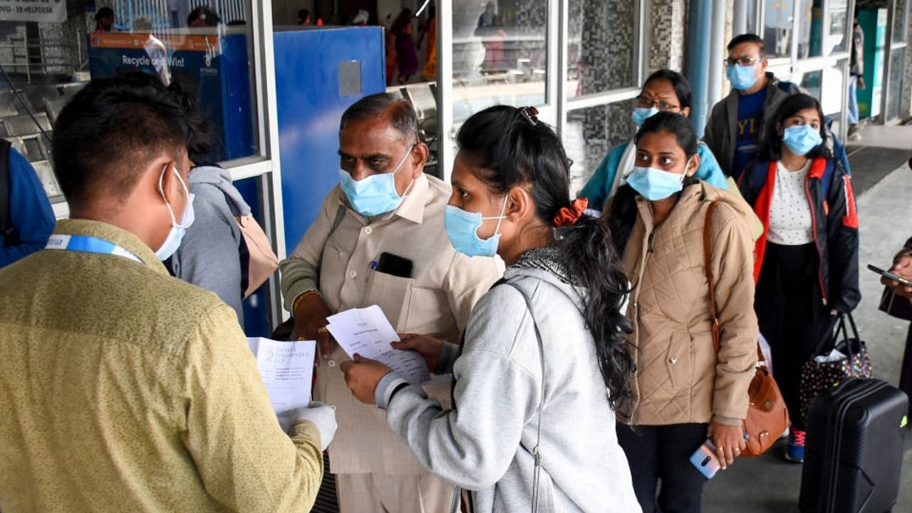 A healthcare worker checks the complete vaccination certificate of the arriving passengers, at Bandra Terminal, in Mumbai, Thursday, Dec. 9, 2021. Credit: PTI Photo