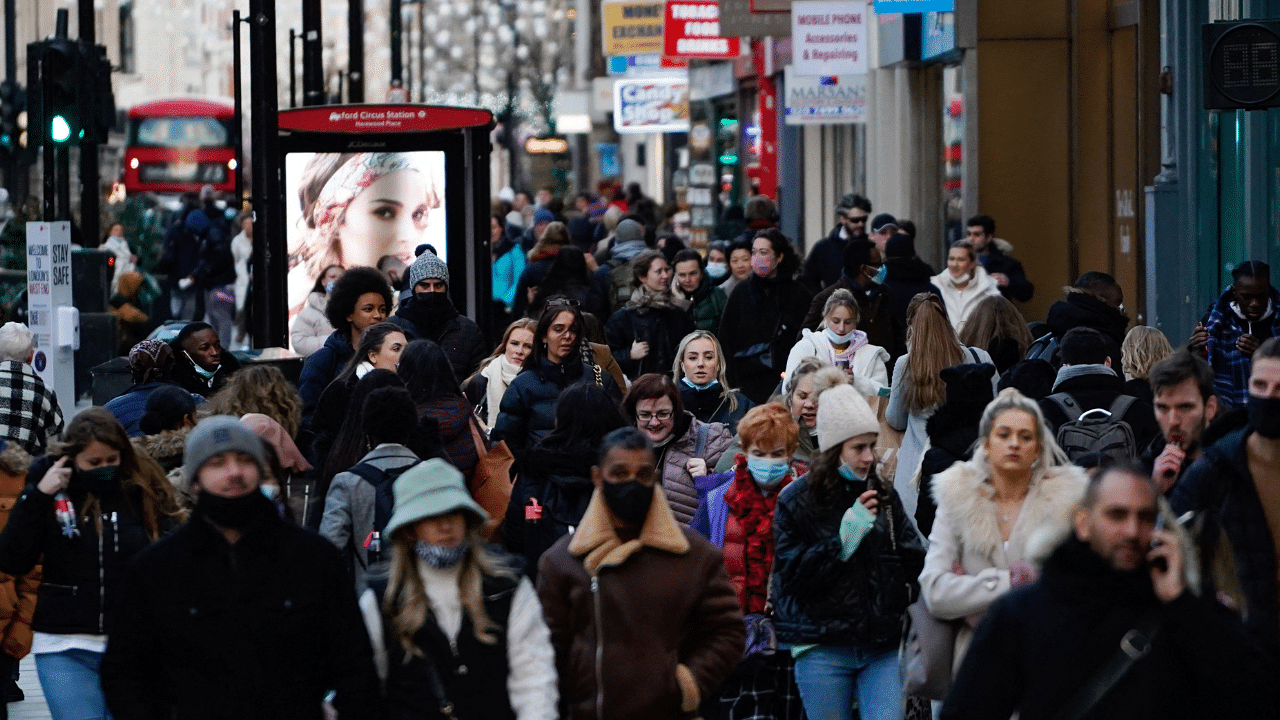 Shoppers, some wearing face coverings to combat the spread of the coronavirus walk along Oxford Street in central London. Credit: AFP Photo