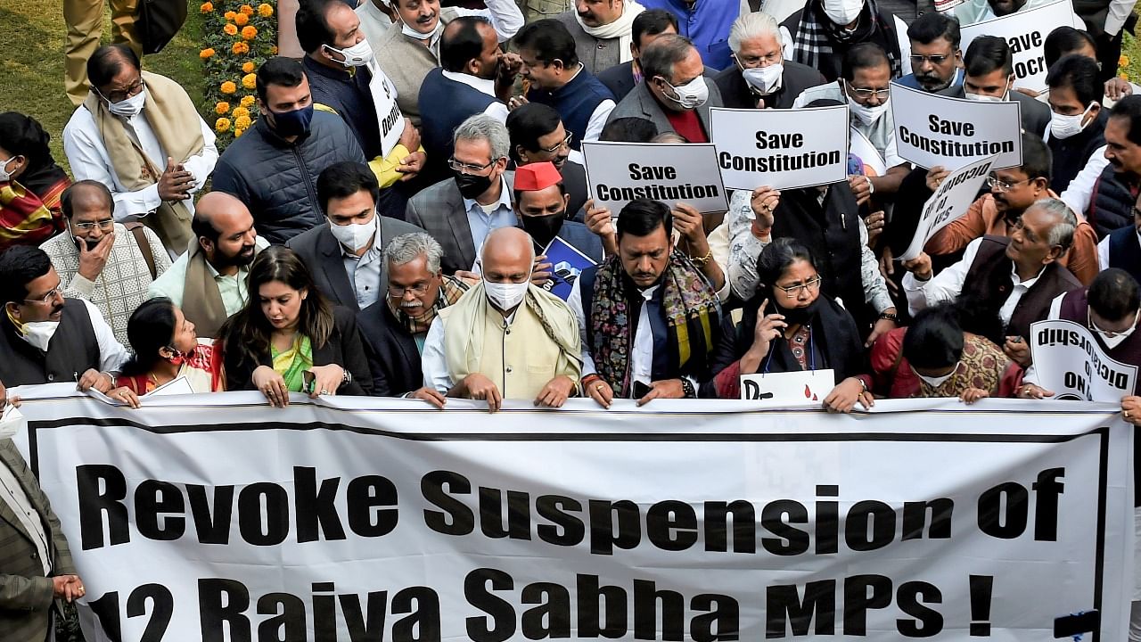 Opposition parties’ members participate in a protest march demanding revocation of the suspension of 12 Rajya Sabha MPs, at Parliament premises in New Delhi. Credit: PTI File Photo