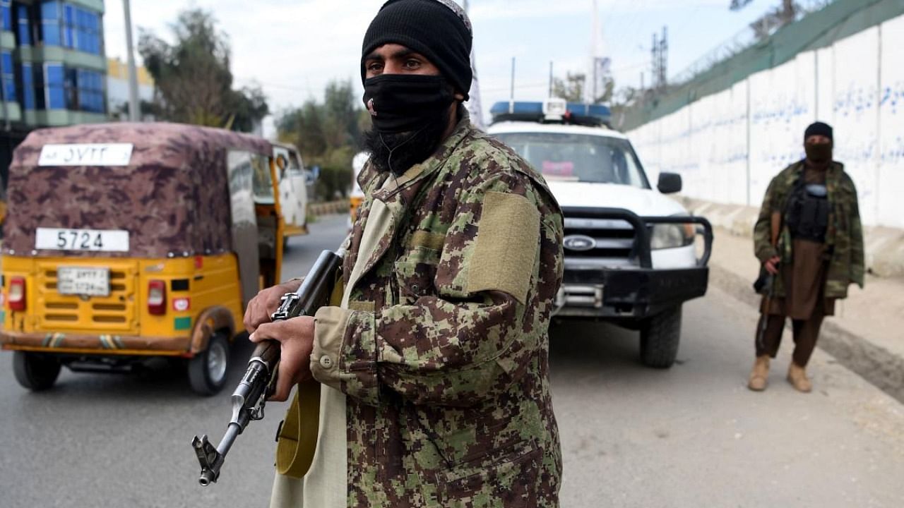 Taliban fighters stand gguard along a roadside in Jalalabad. Credit: AFP Photo