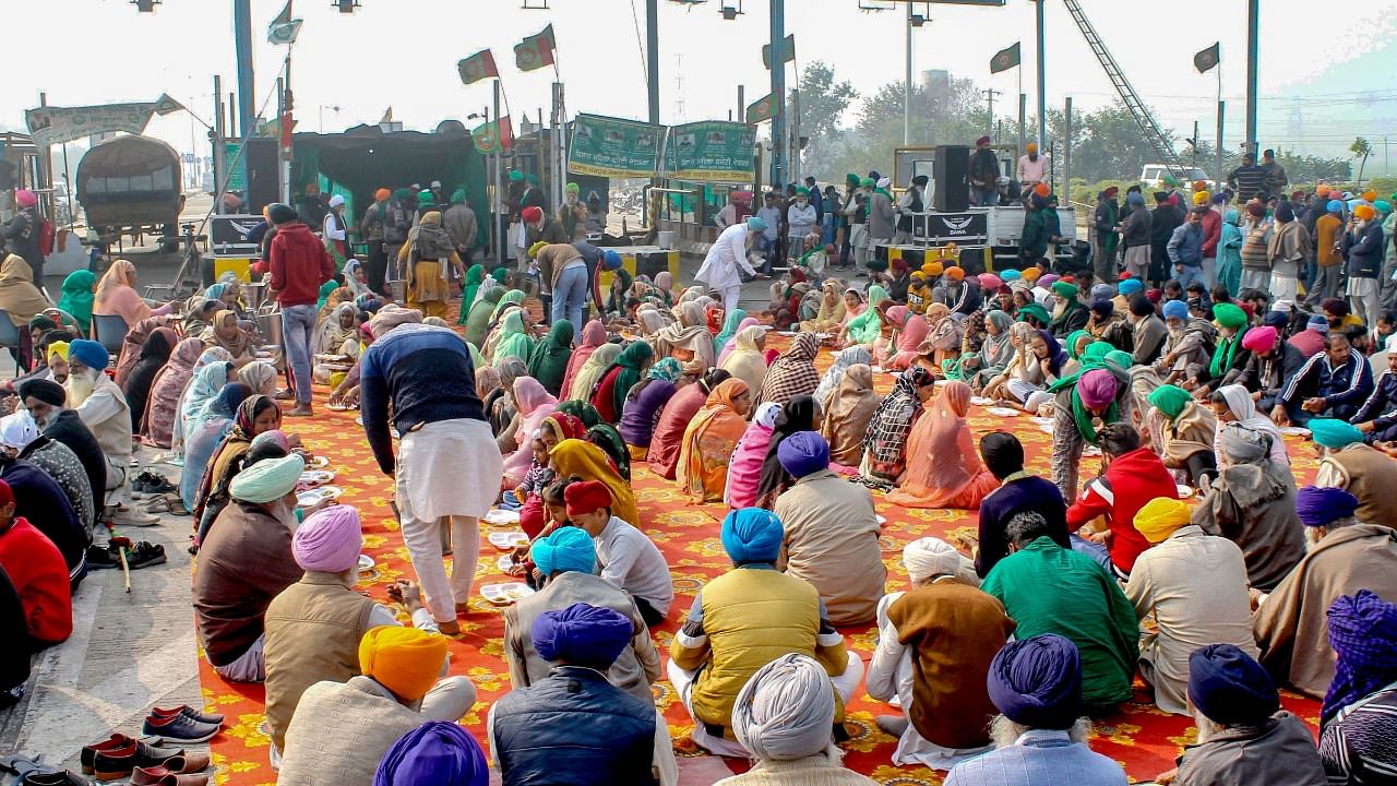 Farmers, including women, danced to the beats of dhol, sang songs and distributed sweets, among themselves. Credit: PTI Photo