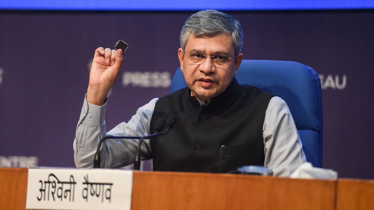 IT and Telecom Minister Ashwini Vaishnaw displays a semiconductor chip at a media briefing. Credit: PTI Photo