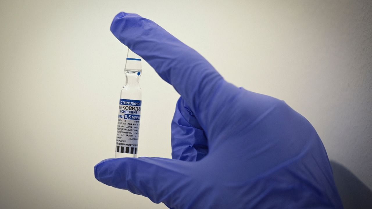 A healthcare worker shows a vial with Russia's Sputnik V Covid-19 vaccine. Credit: AFP File Photo