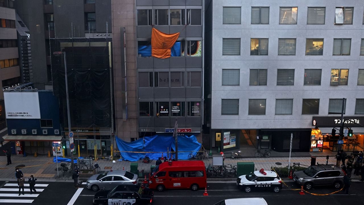 Emergency vehicles are seen in front of an office building, where a fire broke out in Osaka. Credit: AFP Photo