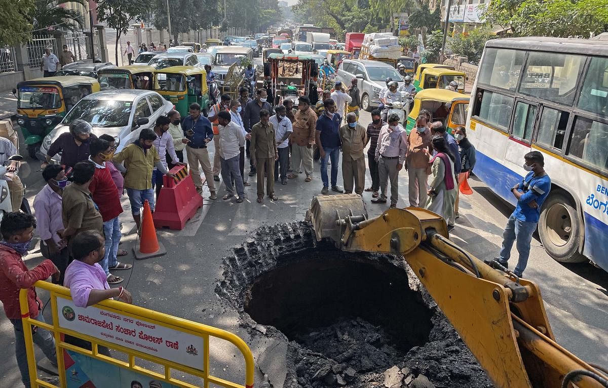 A portion of the busy JC road in central Bengaluru caved in on Thursday, panicking motorists and local residents. Credit: DH Photo