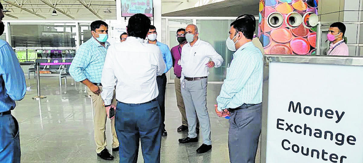 Deputy Commissioner Dr Rajendra K V is briefed by officials about the preparedness to detect Covid-19 cases at Mangalore International Airport on Friday.