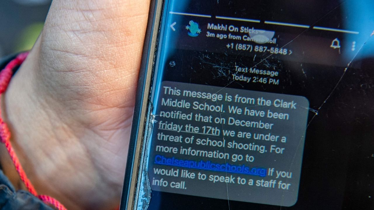A mother in Chelsea, Massachusetts, shows a text she received explaining her child’s school is under the threat of a school shooting. Credit: AFP Photo