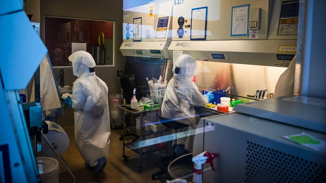 Technicians wearing full body protection suits work inside a biosafety level 3 Covid-19 research laboratory at the African Health Research Institute (AHRI) in Durban, South Africa, on Wednesday, Dec. 15, 2021. Credit: Bloomberg photo