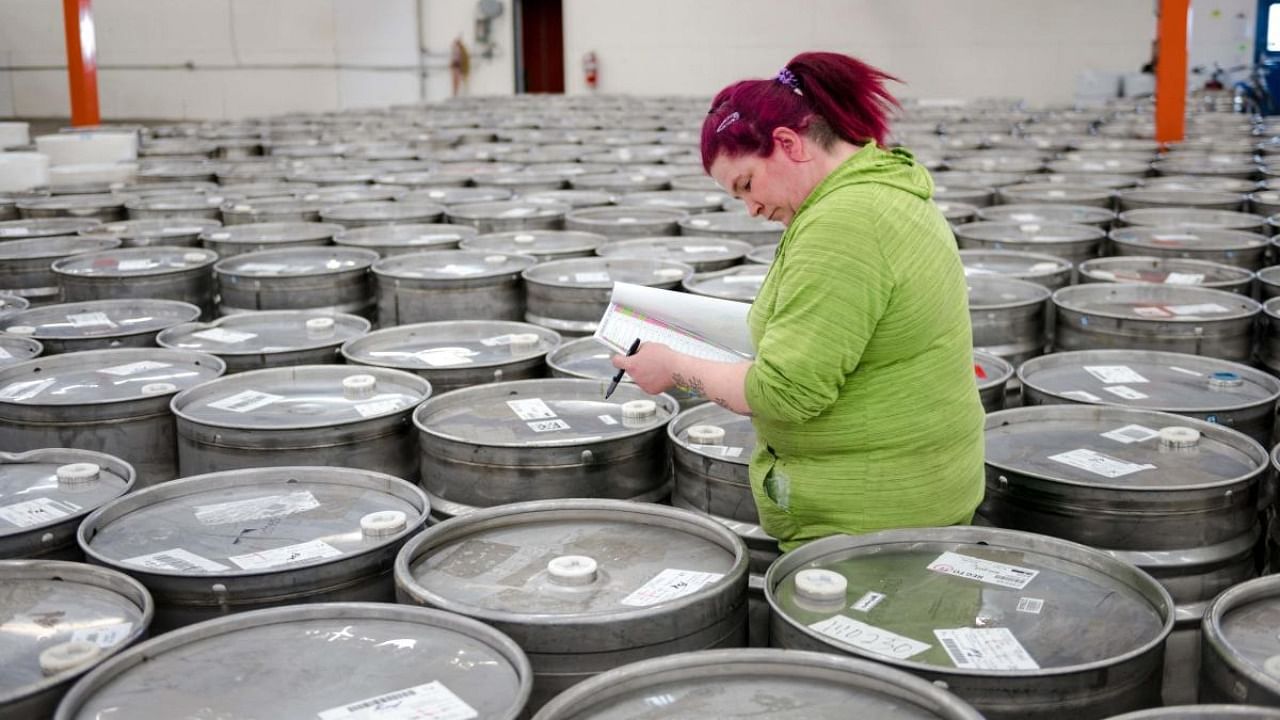 An employee helps to identify and sort empty barrels returned by producers at one of two maple syrup reserves at the Quebec Maple Syrup Producers storage facility in Laurierville, Quebec. Credit: AFP Photo