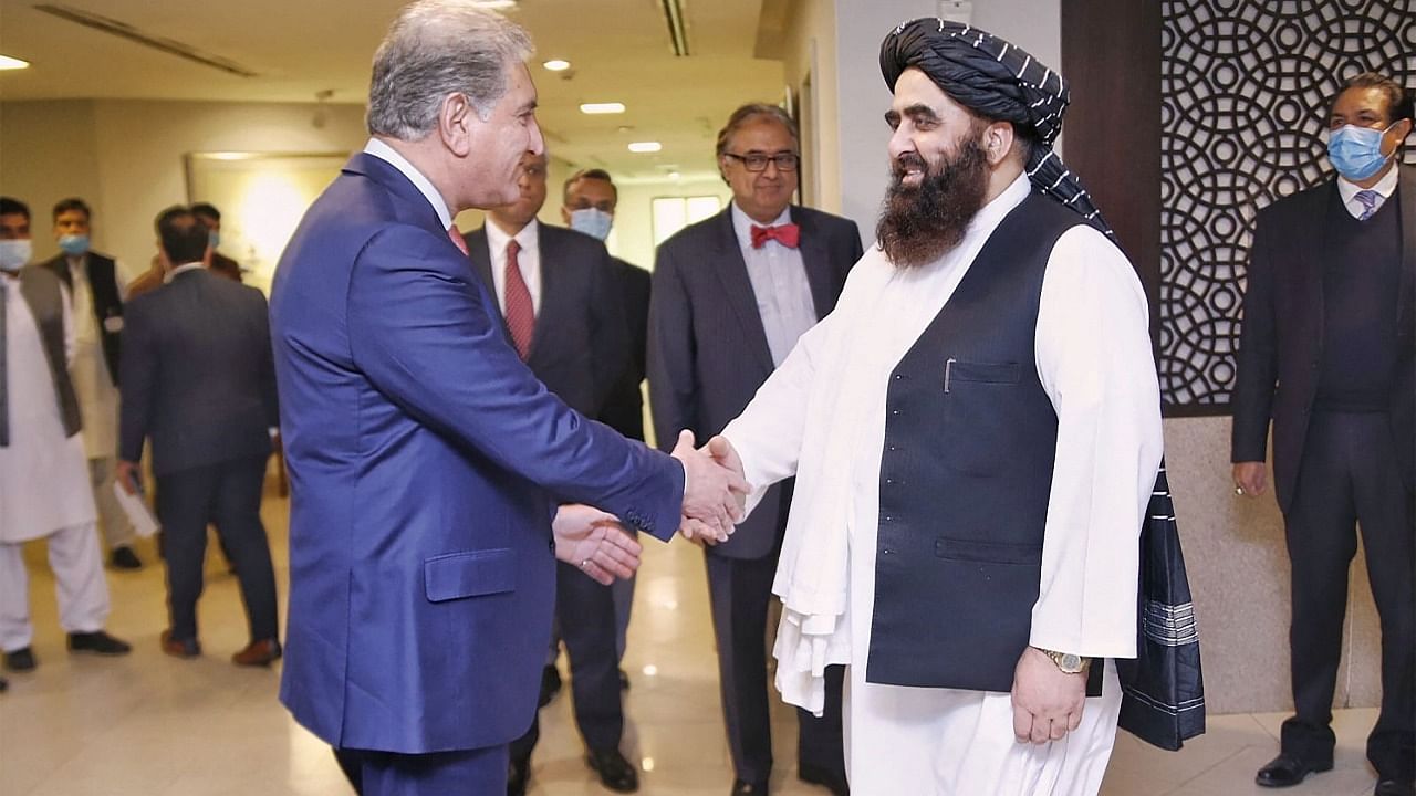 Pakistan's Foreign Minister Shah Mahmood Qureshi (L) shaking hands with Afghanistan's Taliban Foreign Minister Amir Khan Muttaqi before their meeting in Islamabad. Credit: AFP File Photo
