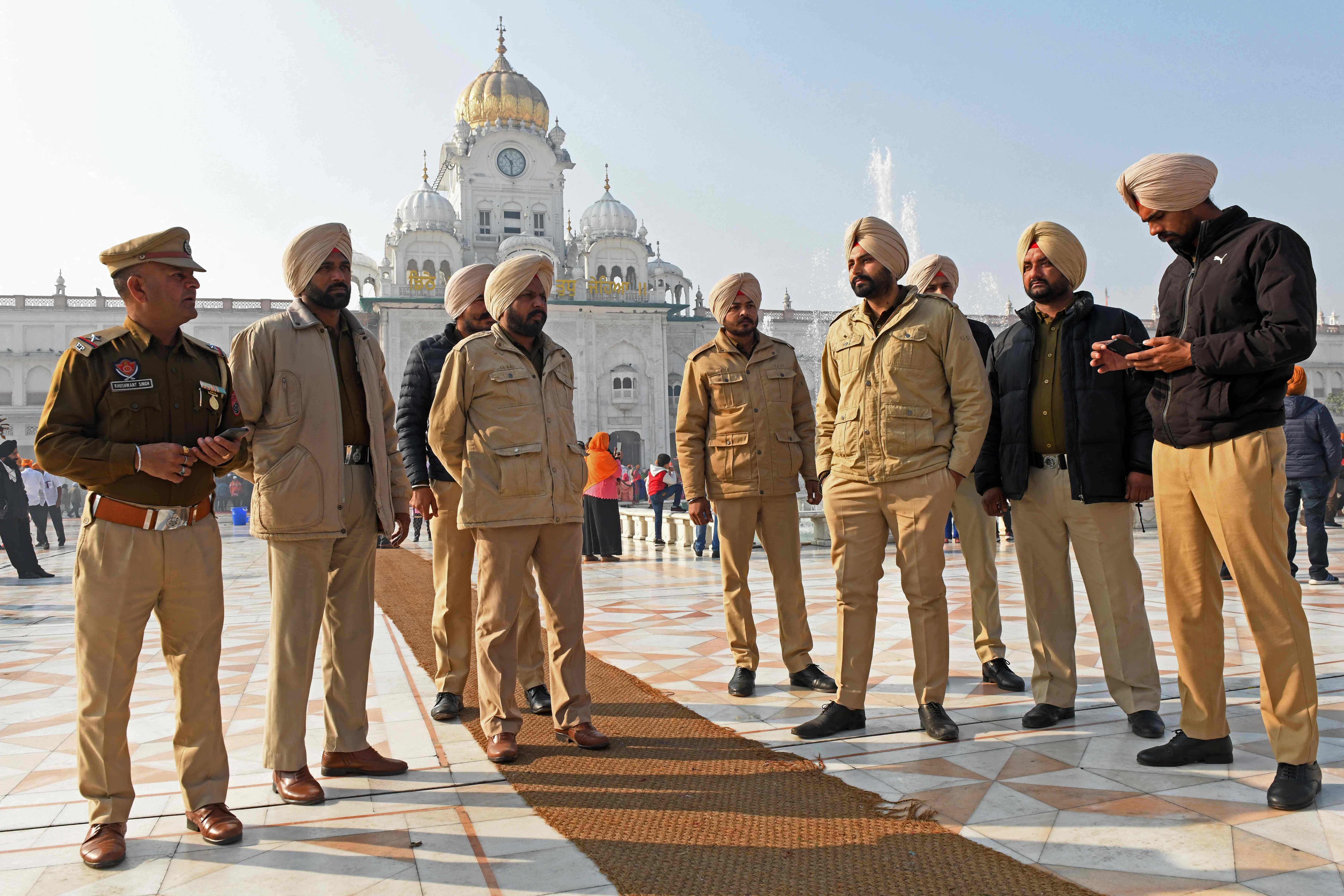 Policemen stand guard outside the Golden Temple in Amritsar a day after a man was beaten to death for allegedly trying to commit an act of sacrilege at the holiest shrine of the Sikh faith. Credit: AFP Photo
