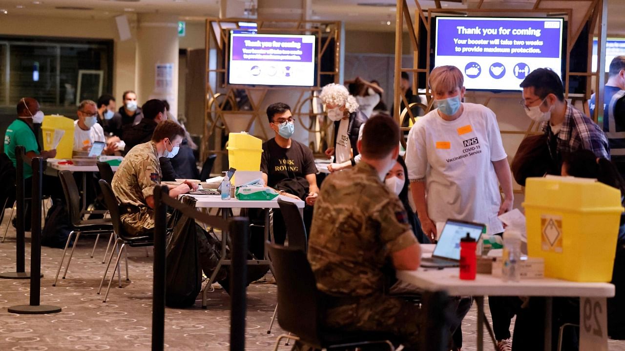 Members of the armed forces help out at the Covid-19 mass vaccination event inside the newly-set up Wembley Stadium vaccination centre in London. Credit: PTI Photo