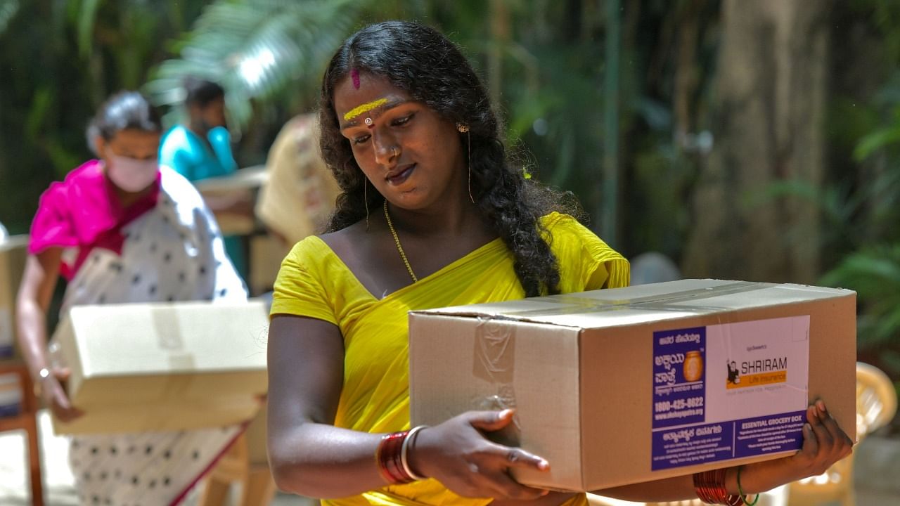 A transgender person collects free groceries kits distributed by a private organisation during the Covid-19 pandemic, in Bangalore. Credit: AFP File Photo