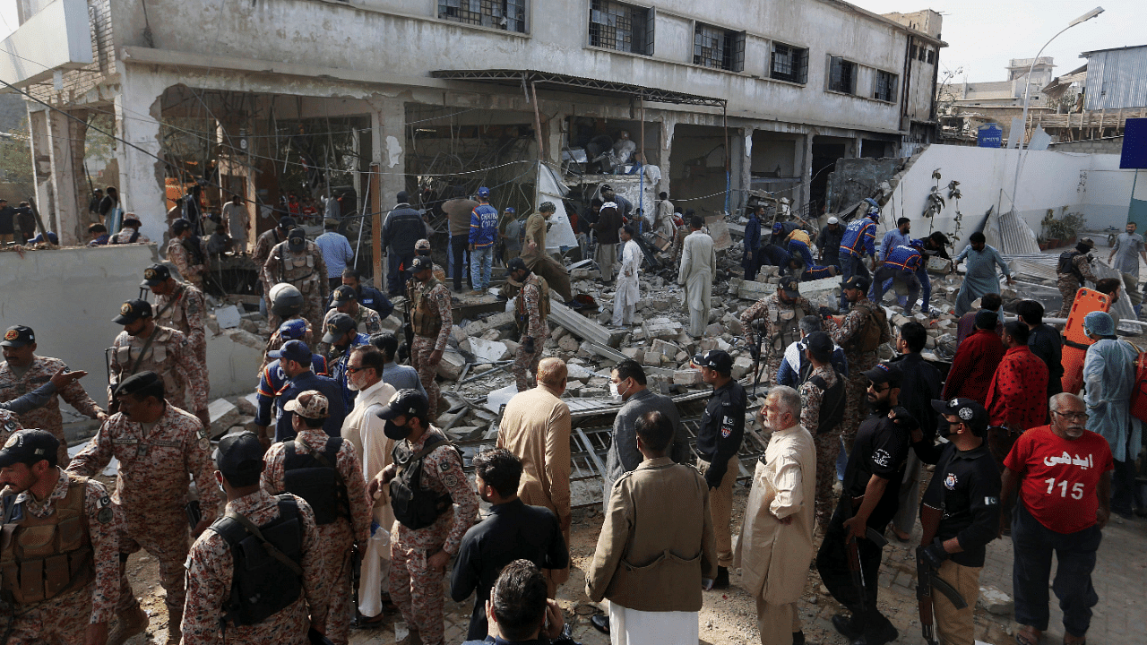 Pakistani security personnel and rescuers inspect the scene of a gas explosion in Karachi. Credit: AP Photo