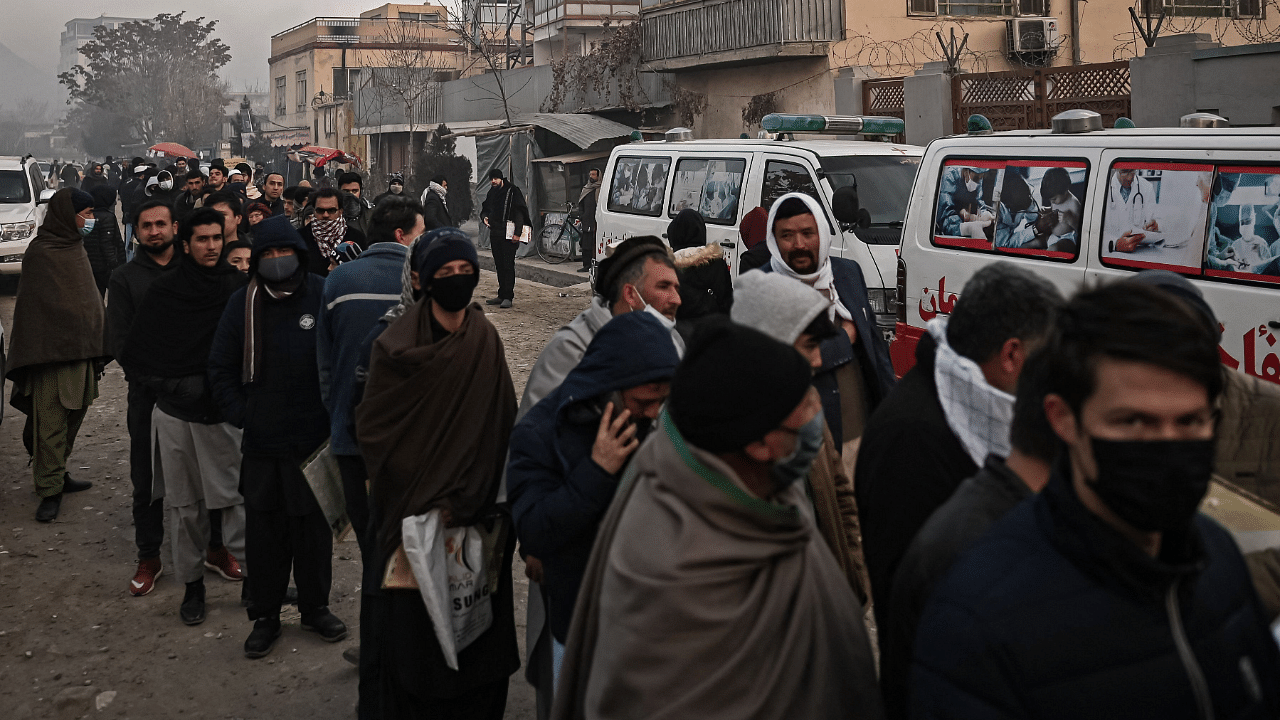 People queue to enter the passport office at a checkpoint in Kabul. Credit: AFP Photo
