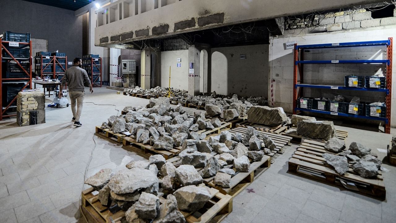 A worker at the Mosul Museum walks past artefact fragments to be reconstructed and reassembled at the Mosul Museum in Iraq's northern city. Credit: AFP Photo