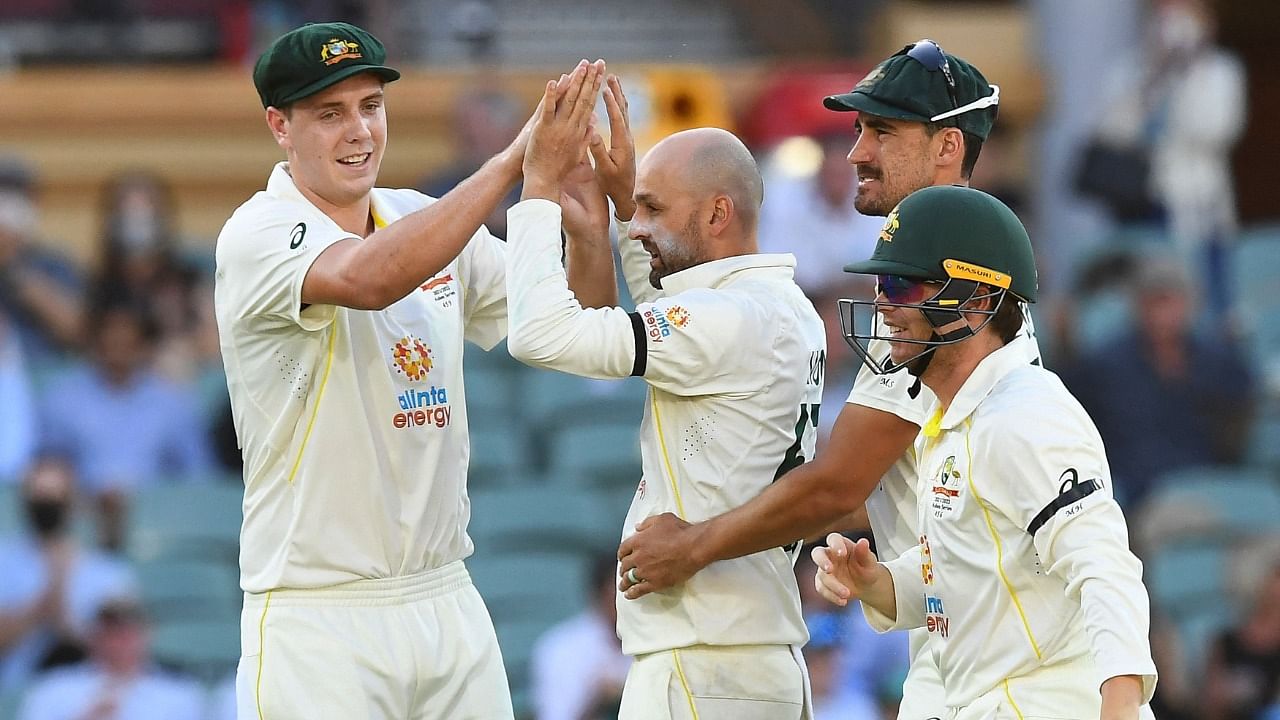 Australia's Nathan Lyon (C) celebrates his wicket of England's batsman Ollie Robinson (not pictured) with teammates. Credit: AFP Photo