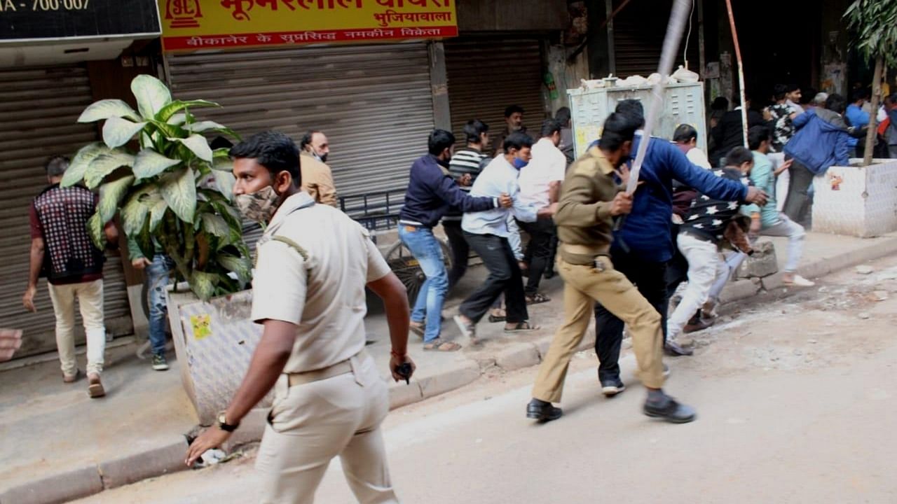 Police personnel lathi charge after a clash broke out during Kolkata Municipal Corporation elections, in Kolkata on Sunday. Credit: IANS Photo