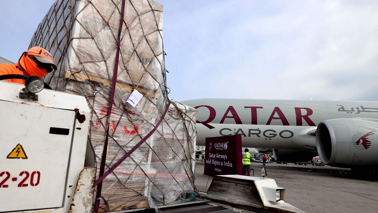 Workers load medical aid to be flown in a cargo aircraft convoy directly to destinations in India, at Qatar's Hamad International Airport in Doha. Credit: AFP File Photo