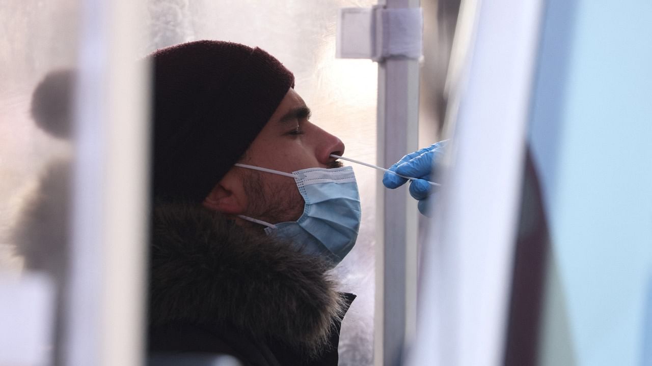 A person is tested for COVID-19 in Times Square as the Omicron coronavirus variant continues to spread. Credit: Reuters Photo