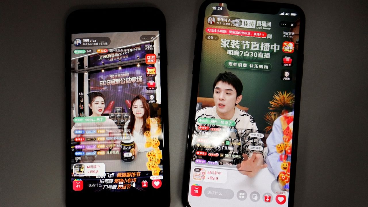 Livestreaming sessions by Chinese livestreamers Li Jiaqi and Viya (L) are seen on Alibaba's e-commerce app Taobao displayed on mobile phones. Credit: Reuters Photo