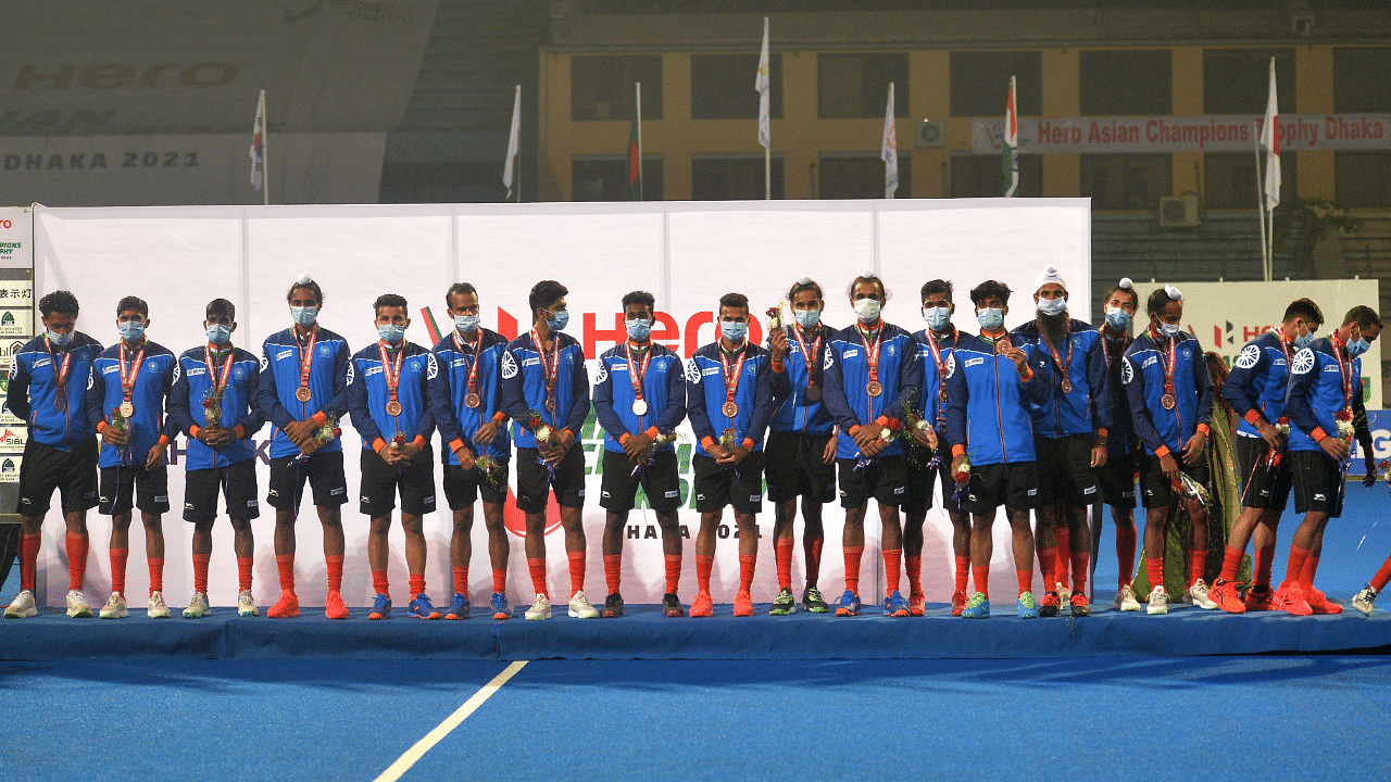India's team pose for pictures as they celebrate their third place in the Asian Champions Trophy men's field hockey tournament in Dhaka. Credit: AFP Photo