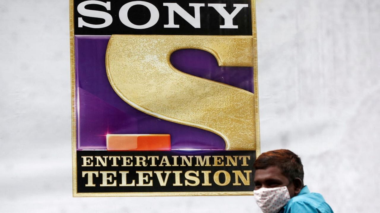 A man stands next to a banner of Sony Entertainment, outside a film set in Mumbai. Credit: Reuters photo