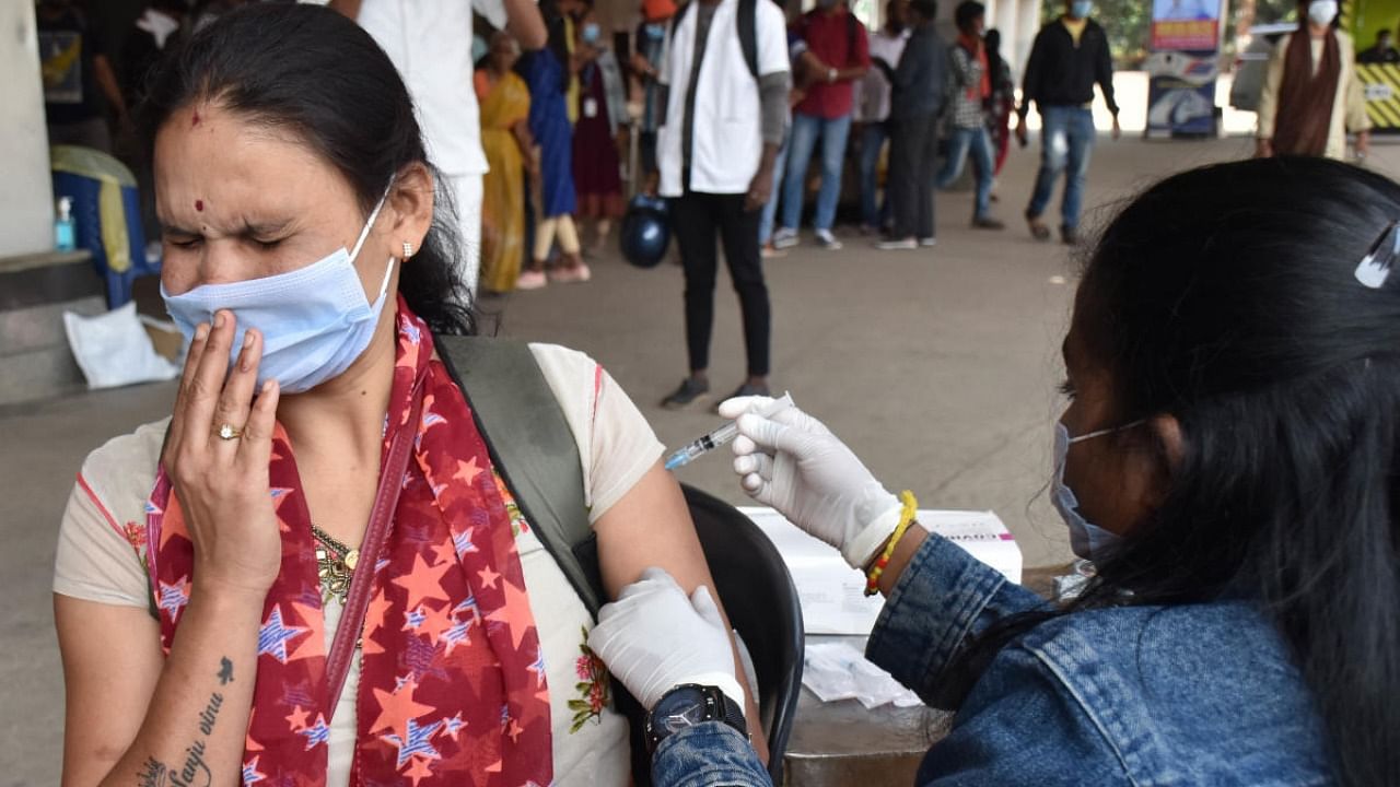 A health worker administers vaccines at the KSR railway station on Wednesday. Credit: DH Photo/B K Janardhan