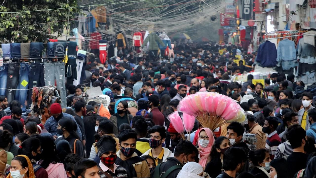 People shop at a crowded market ahead of Christmas during the ongoing coronavirus disease pandemic, in New Delhi. Credit: Reuters Photo