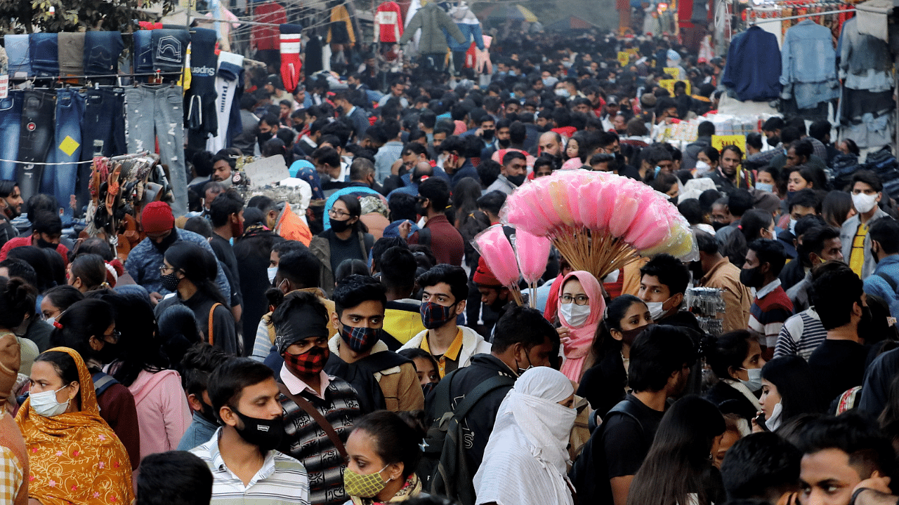 People shop at a crowded market ahead of Christmas during the ongoing coronavirus disease (Covid-19) pandemic, in New Delhi. Credit: Reuters Photo