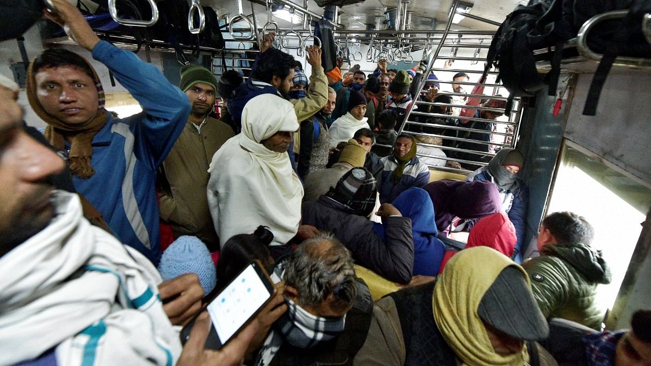 Gautam Buddha Nagar: Commuters travel in a crowded Covid Special EMU train, amid concern over rising Omicron cases, in Gautam Buddha Nagar, Thursday, Dec. 23, 2021. Credit: PTI Photo