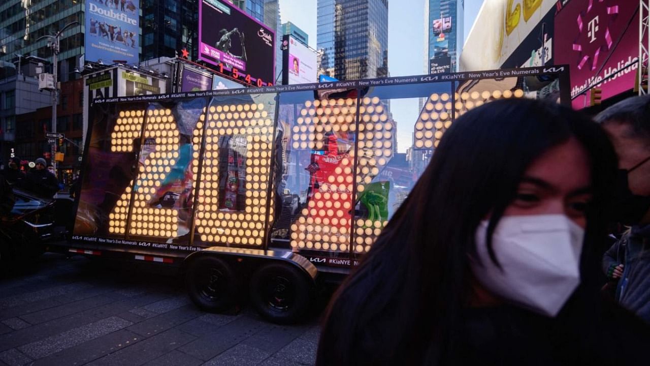 People pose for photos before the 2022 numerals to be used at a new year countdown event in Times Square. Credit: AFP Photo