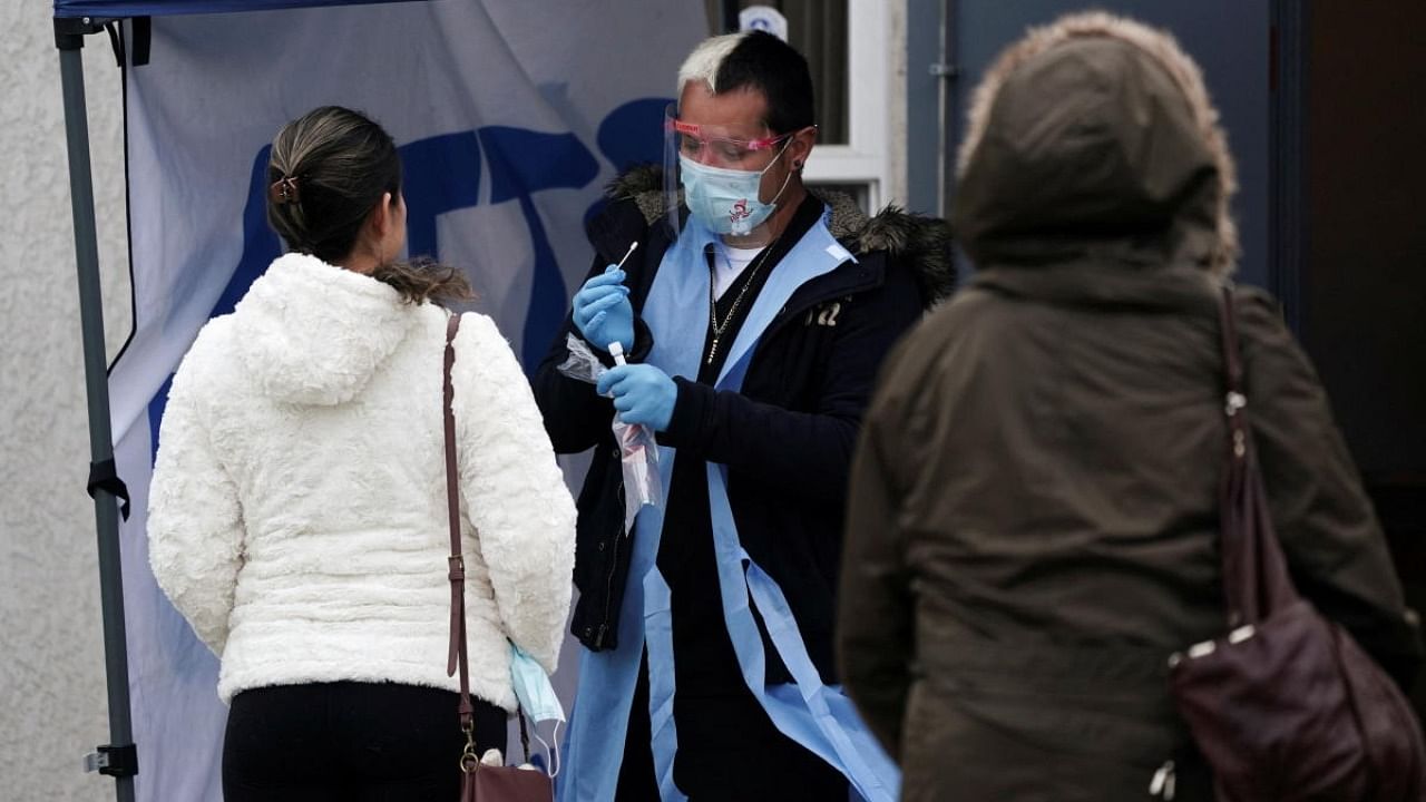 A healthcare worker collects a nasal swab sample at a Covid-19 test site operated at Park Hills Community Church during the holiday season as the Omicron variant threatens to increase case numbers in View Park, California. Credit: Reuters photo