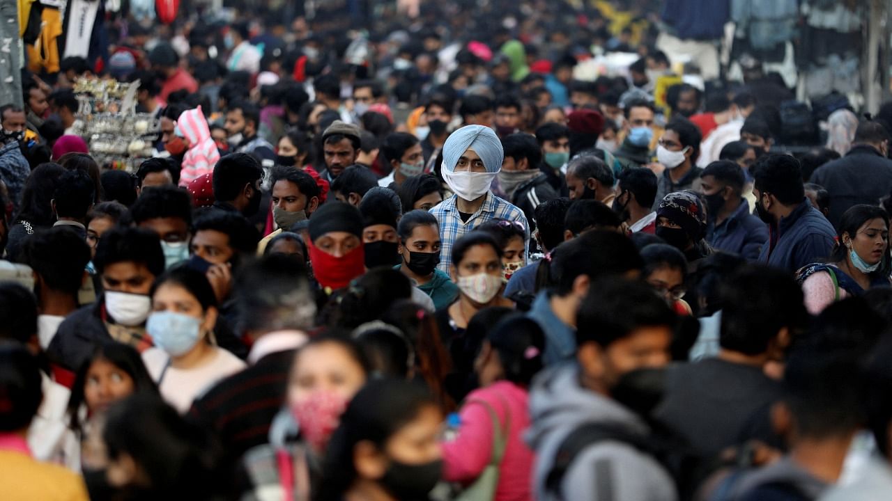 People shop at a crowded market ahead of Christmas during the ongoing coronavirus disease (Covid-19) pandemic, in New Delhi. Credit: Reuters Photo