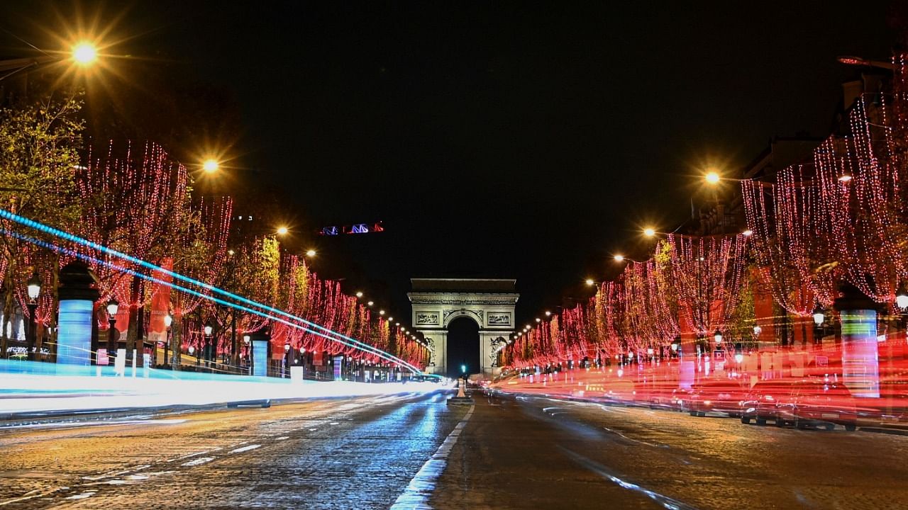 A picture shows a general view of the Champs-Elysees Avenue and the Arc de Triomphe after the inauguration of the Christmas season lights. Credit: AFP File Photo
