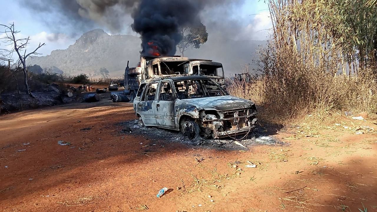 This handout image from the Karenni Nationalities Defense Force (KNDF) taken and released on December 25, 2021 shows burnt vehicles in Hpruso township in Kayah state. Credit: AFP Photo