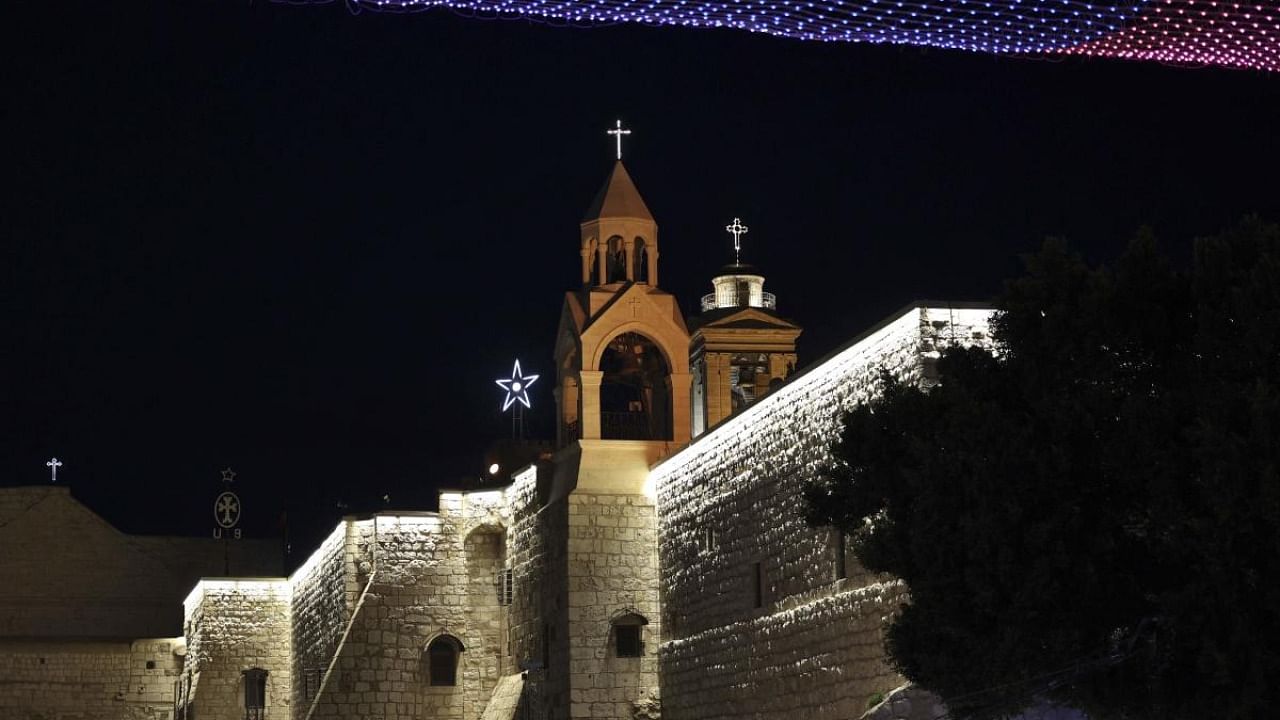 Lights illuminate the Church of the Nativity, revered as the site of Jesus Christ's birth, on Christmas eve in the biblical city of Bethlehem in the Israeli occupied West Bank. Credit: AFP Photo