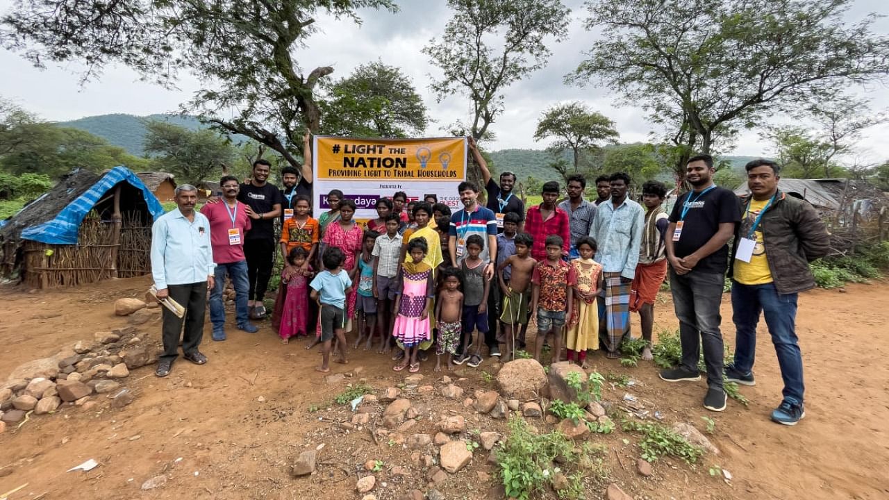 The NGO with the tribals after the lighting was completed. Credit: DH Photo