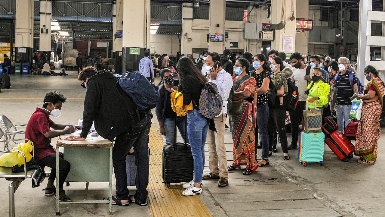Passengers wait to get tested at the Chennai Central Railway Station. Credit: PTI Photo