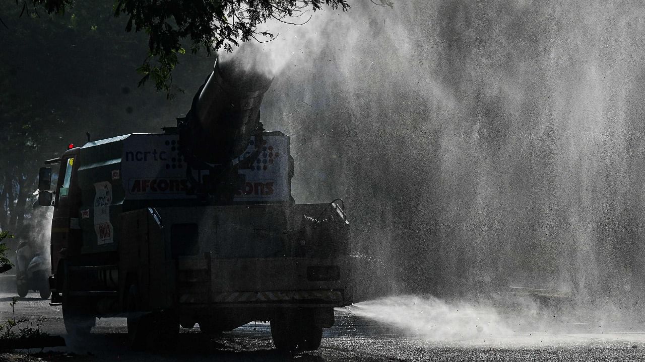 A water sprinkler machine in action to curb dust spread in Delhi, the most polluted capital in the world. Credit: AFP Photo